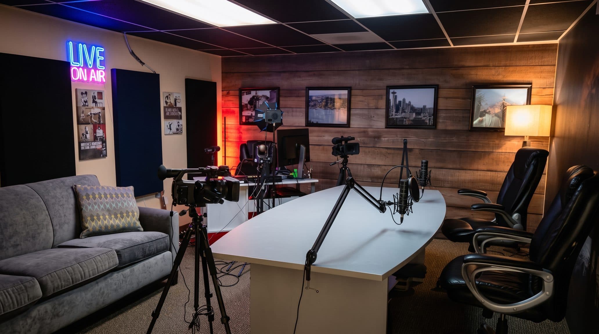 The podcast studio with a neon LIVE ON AIR sign, a white table with two microphones on boom arms, leather chairs, cameras on tripods and a wood plank accent wall